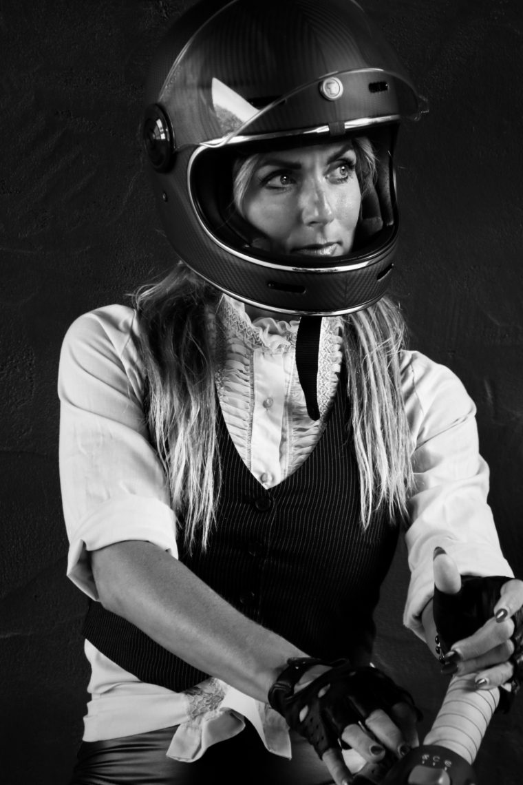 Black and white portrait of Aly in a helmet and leather vest