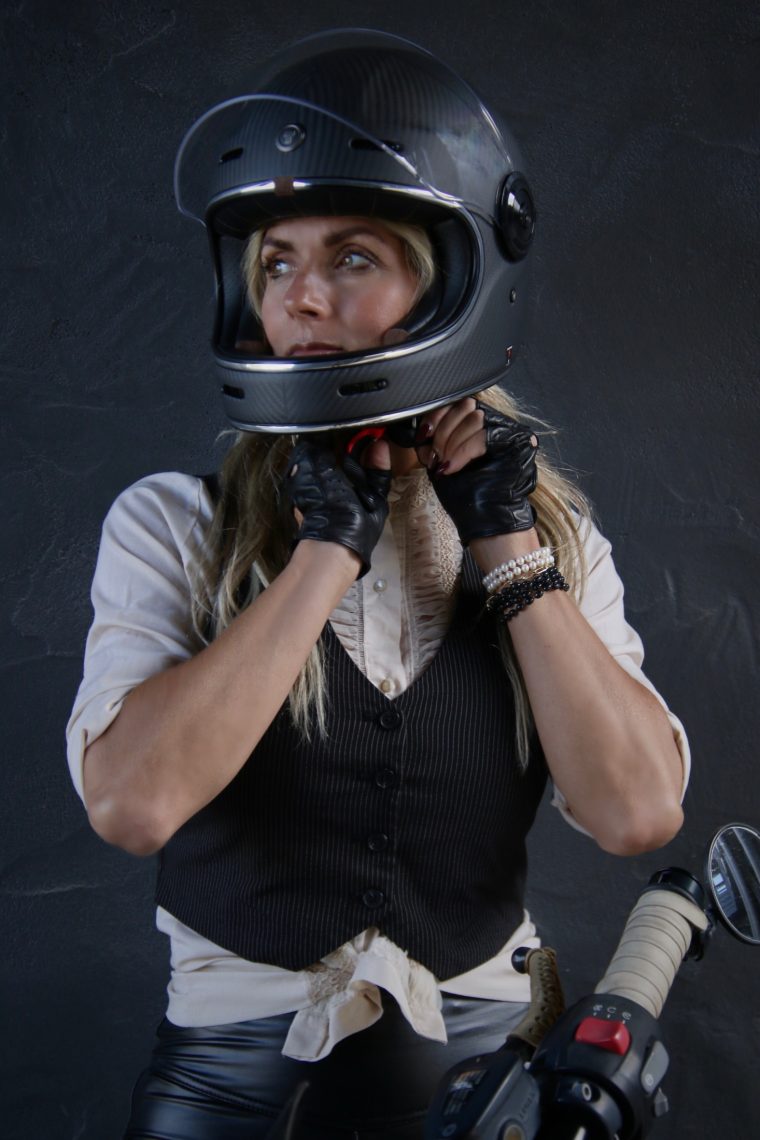 Aly buckling a black Torc helmet