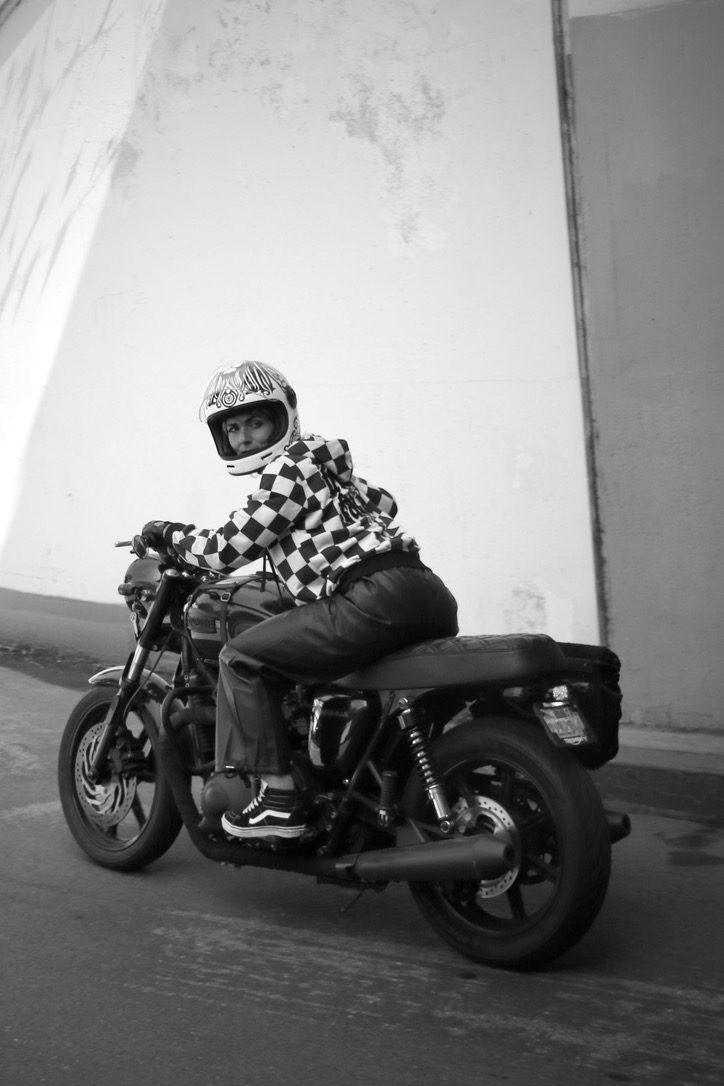 Black and white frame of Aly seated on the motorcycle