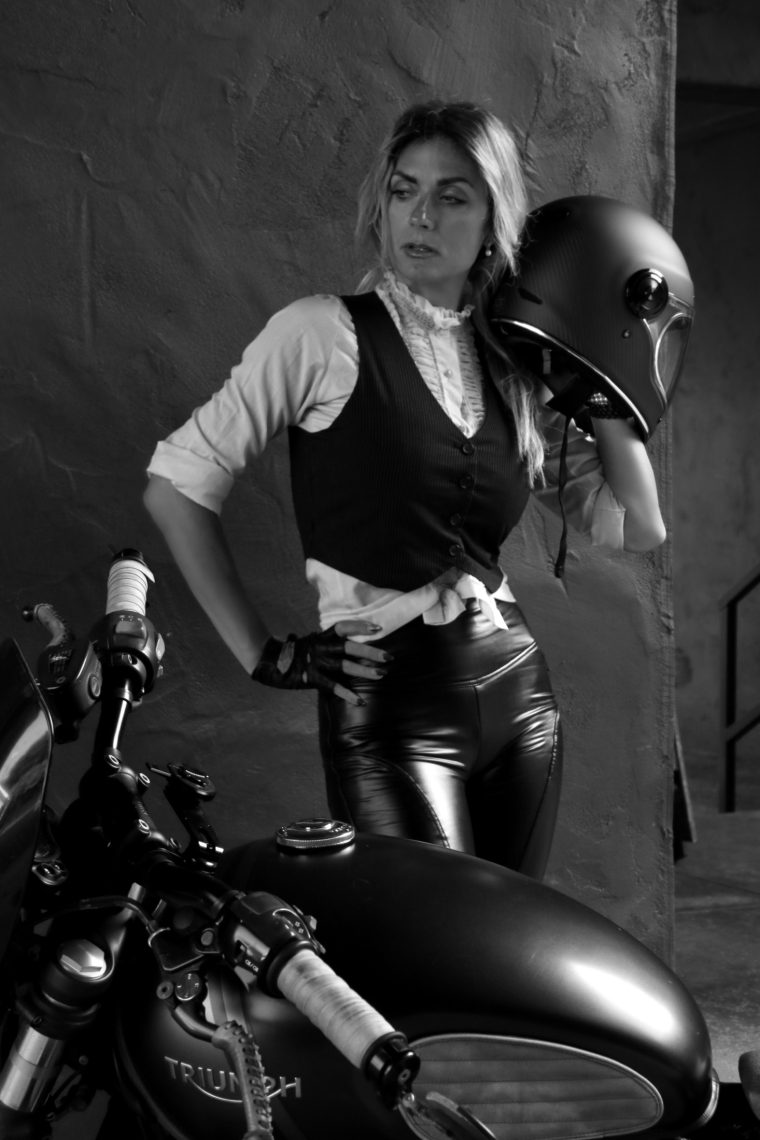 Aly seated on the cafe racer